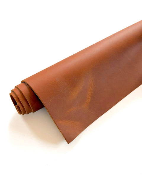 Rolled tan Crazy Horse cowhide pre-cut leather sheet measuring 12 x 24 inches