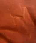 Close-up of tan Crazy Horse leather showing natural distressed markings and pull-up