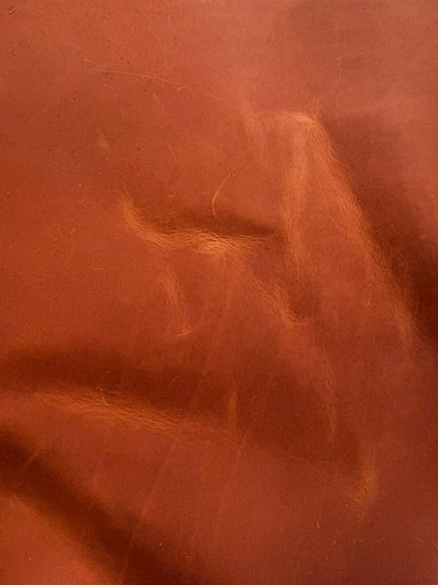 Close-up of tan Crazy Horse leather showing natural distressed markings and pull-up