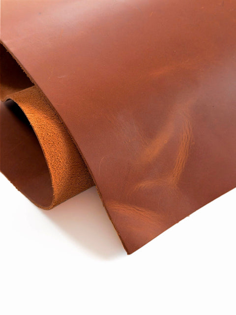 Folded tan Crazy Horse cowhide sheet showing thickness, pull-up finish, and suede back